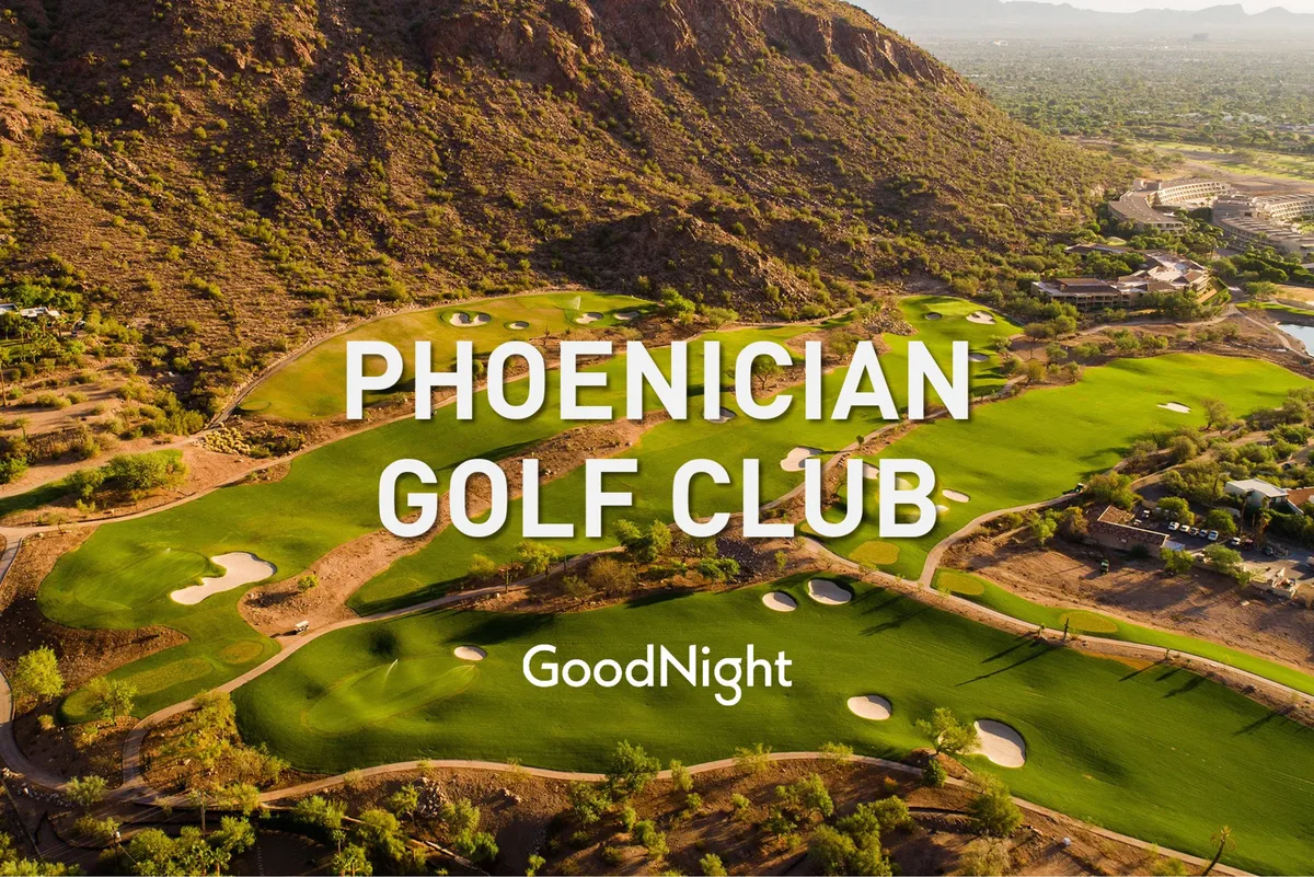 A sweeping view of a golf course with lush green fairways, sand traps, and a majestic mountain backdrop. The clubhouse sits in the distance, and the sky glows with the colors of sunset, suggesting a tranquil yet invigorating setting perfect for golfers.